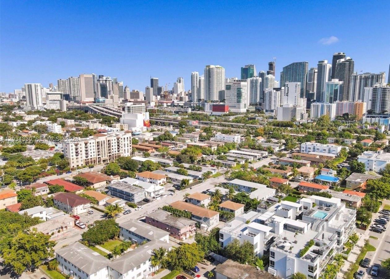 An aerial view of a residential neighborhood with a large city skyline in the background — 550 SW 10th St # 6, Miami FL 33130, MIAMI, FL