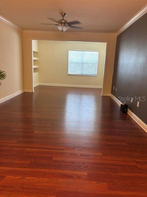 An interior view shows a room with dark wood flooring and a ceiling fan — 143 SOUTHERN PECAN CIRCLE UNIT 206, WINTER GARDEN, FL