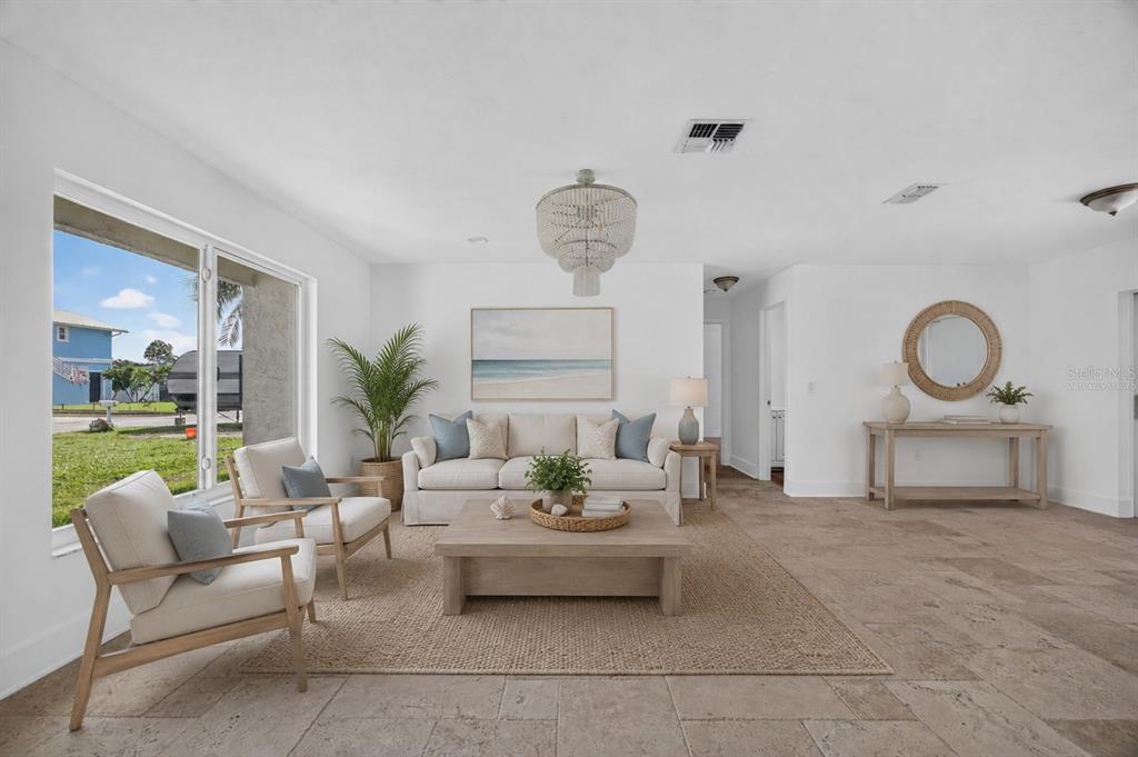 A bright living room features a beige sofa, two armchairs, a coffee table, and tile flooring — 6049 PERTHSHIRE LANE, FORT MYERS, FL