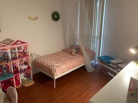 A child's bedroom features a white metal bed with a canopy and a dollhouse — 7035 NW 186th St # D310, Hialeah FL 33015, HIALEAH, FL