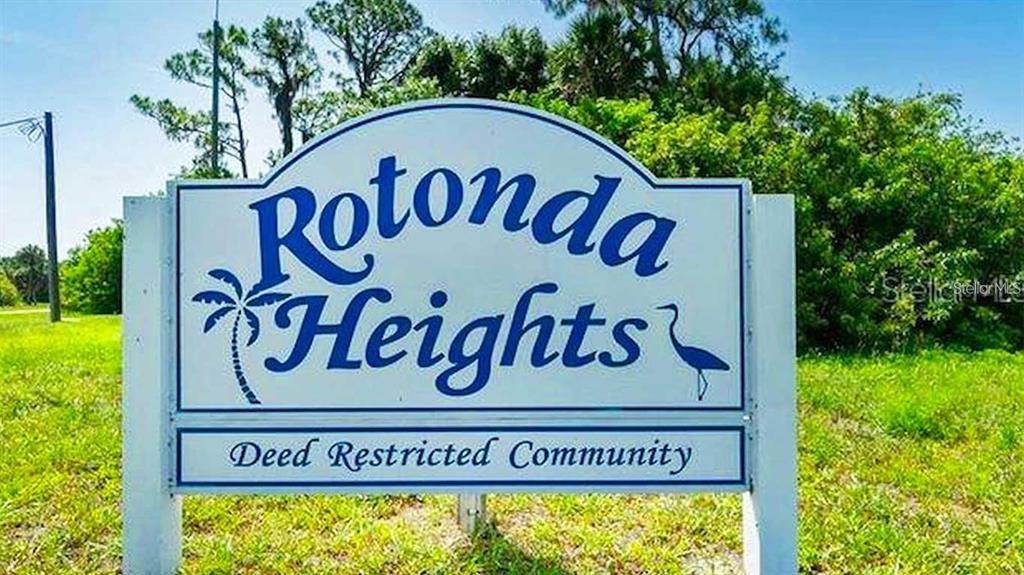 A sign for Rotonda Heights stands in a grassy area surrounded by trees — 116 APRIL ROAD, ROTONDA WEST, FL