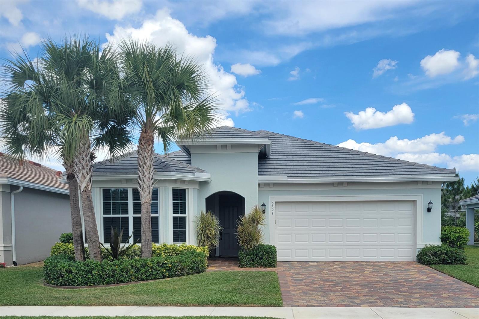 A single-story house with a paver driveway, palm trees, and a two-car garage — 5324 Star Rush Lane, Lake Worth FL 33467, LAKE WORTH, FL