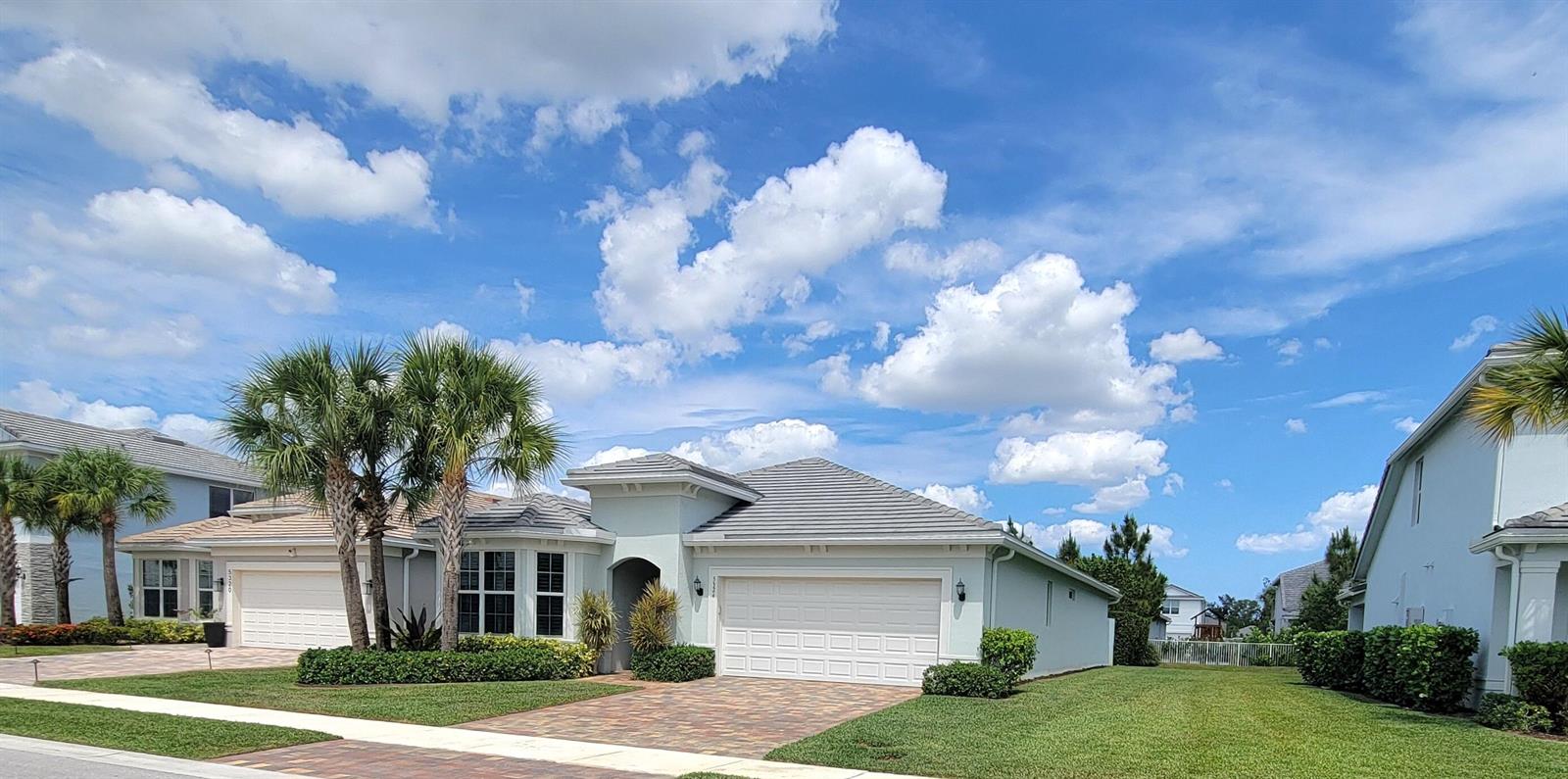 A one-story suburban house with a tiled roof, a two-car garage, and palm trees — 5324 Star Rush Lane, Lake Worth FL 33467, LAKE WORTH, FL