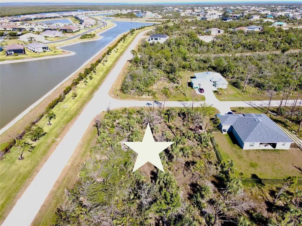 An aerial view shows a vacant, wooded residential lot marked with a large white star — 8045 THRUSO ROAD, PORT CHARLOTTE, FL