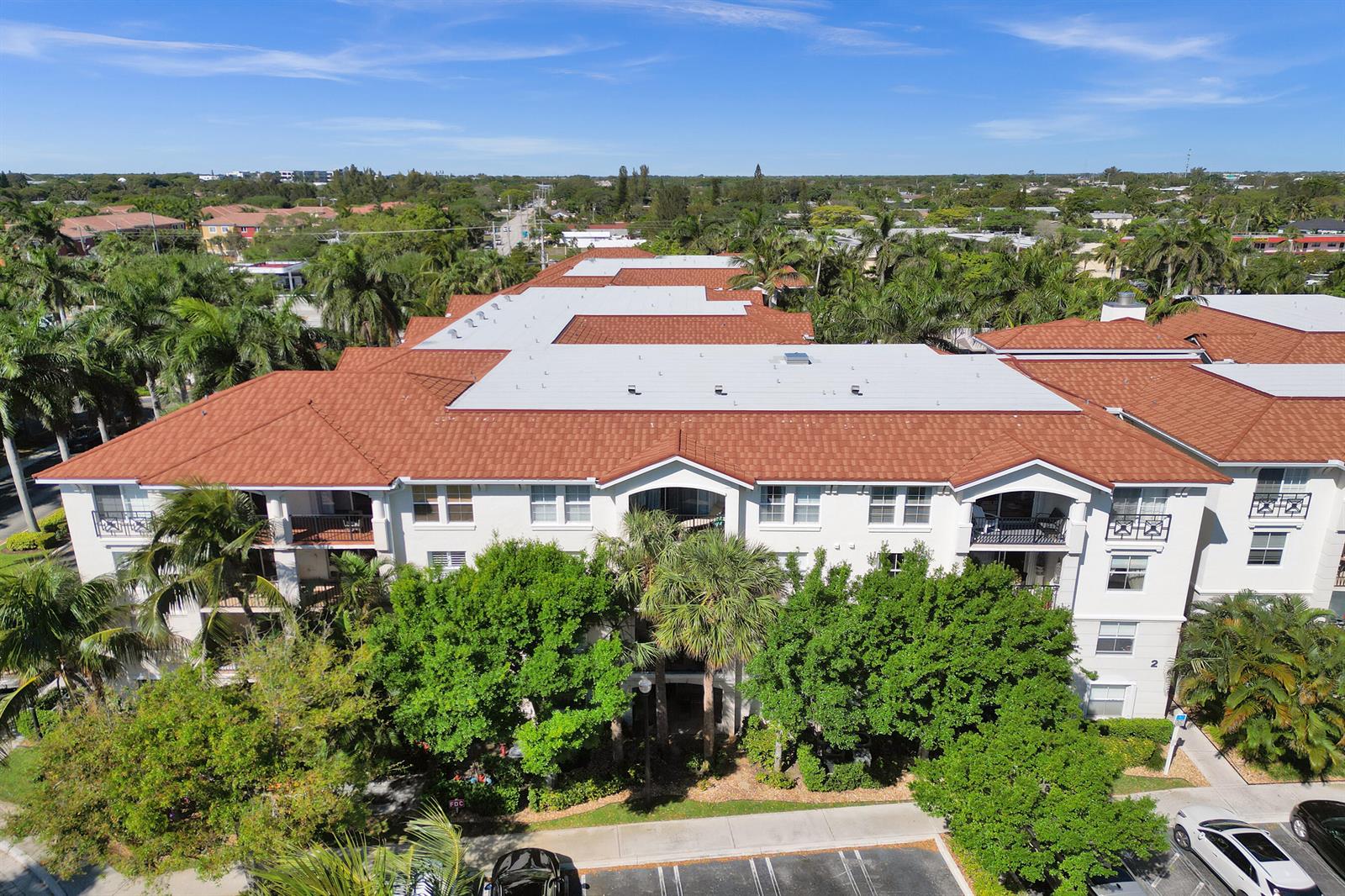 An aerial view of a multi-story apartment building with a red tile roof — 2113 Tuscany Way, Boynton Beach FL 33435, BOYNTON BEACH, FL