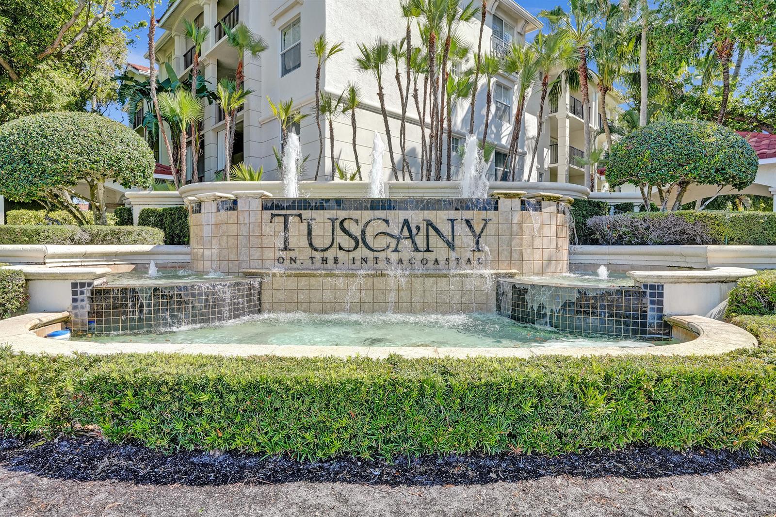 A multi-tiered stone fountain with the name Tuscany on the Intracoastal stands before apartments — 2113 Tuscany Way, Boynton Beach FL 33435, BOYNTON BEACH, FL