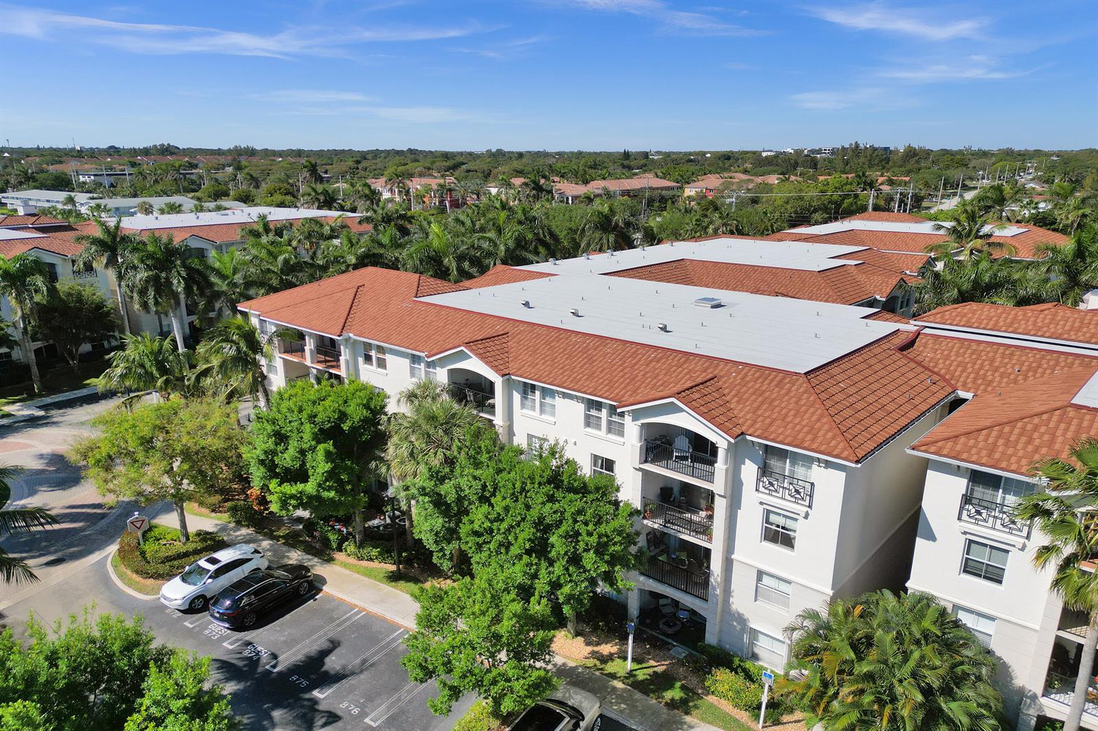 An aerial view shows a multi-story apartment building with a red tile roof — 2113 Tuscany Way, Boynton Beach FL 33435, BOYNTON BEACH, FL