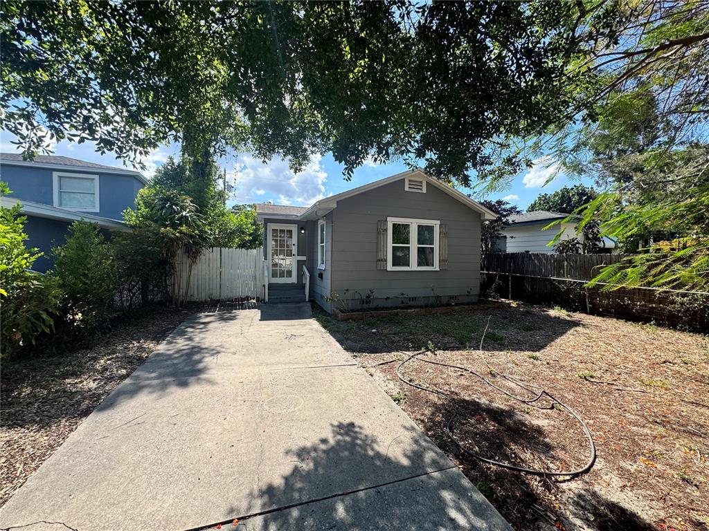 A gray, single-story house with a concrete driveway and a front yard — 3134 17TH STREET N, ST PETERSBURG, FL