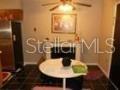 A small dining area features a round white table, dark tile flooring, and a fireplace — 1723 SW 68TH TERRACE, GAINESVILLE, FL