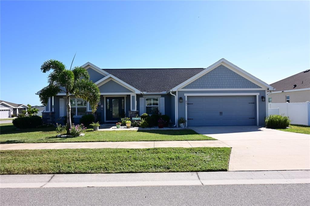 A blue single-story house with a two-car garage, a palm tree, and a front lawn — 891 GALLOWAY STREET, LAKE ALFRED, FL