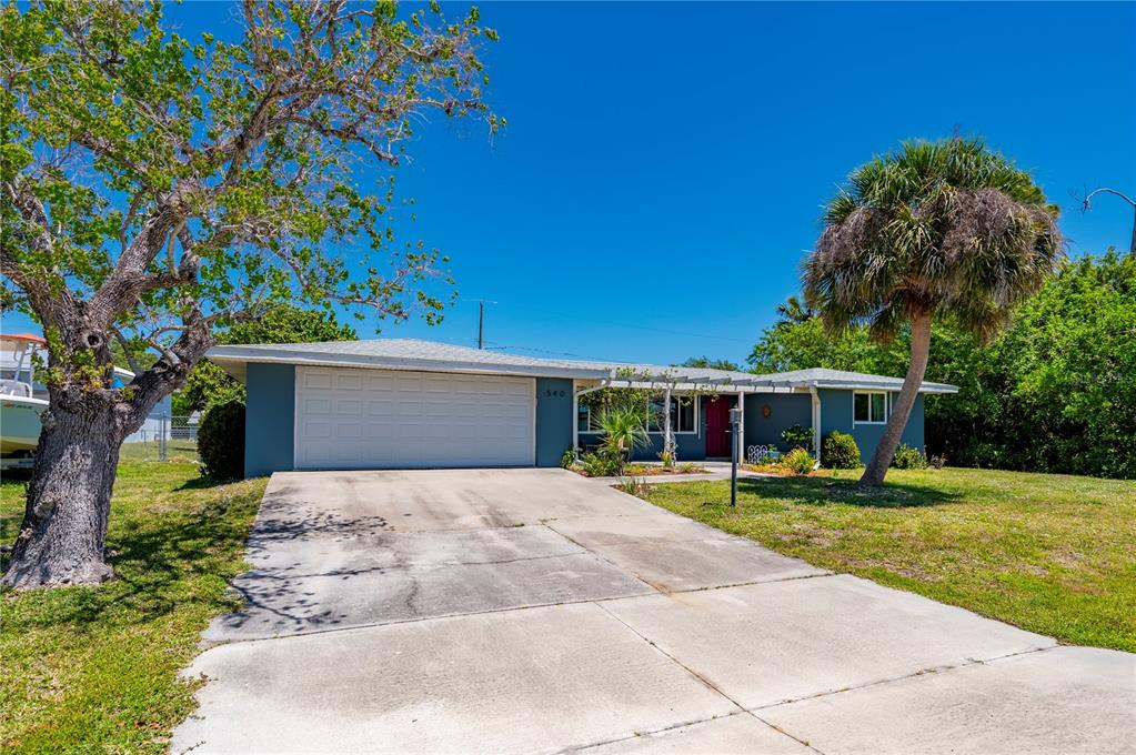 An aerial view shows a single-story house with a white outline on a grassy lot — 540 GROVE AVENUE NW, PORT CHARLOTTE, FL
