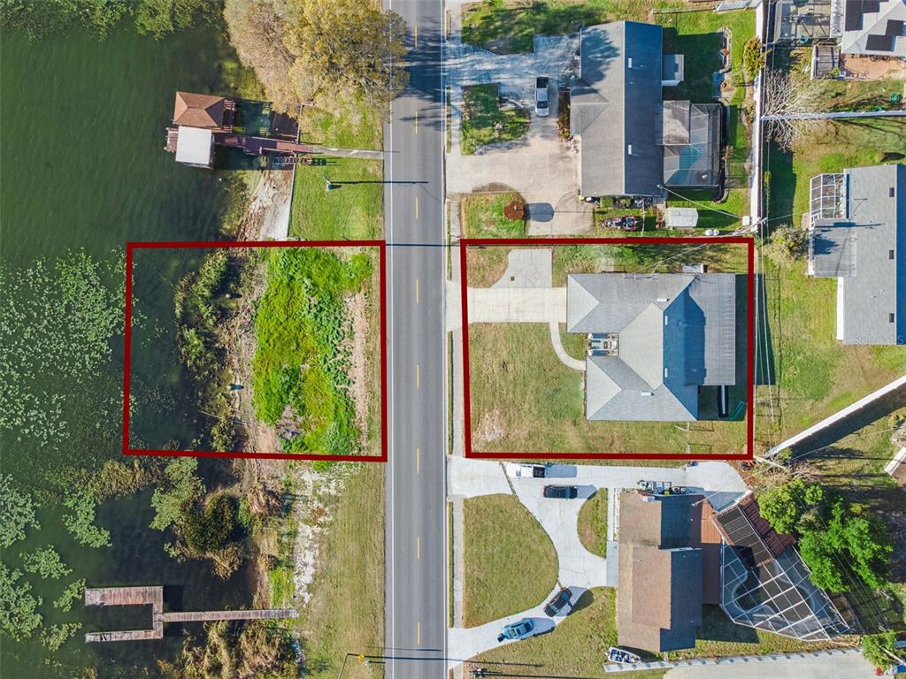 An aerial view shows two adjacent lots, one with a house and one undeveloped — 1106 LAKE ARIANA BOULEVARD, AUBURNDALE, FL