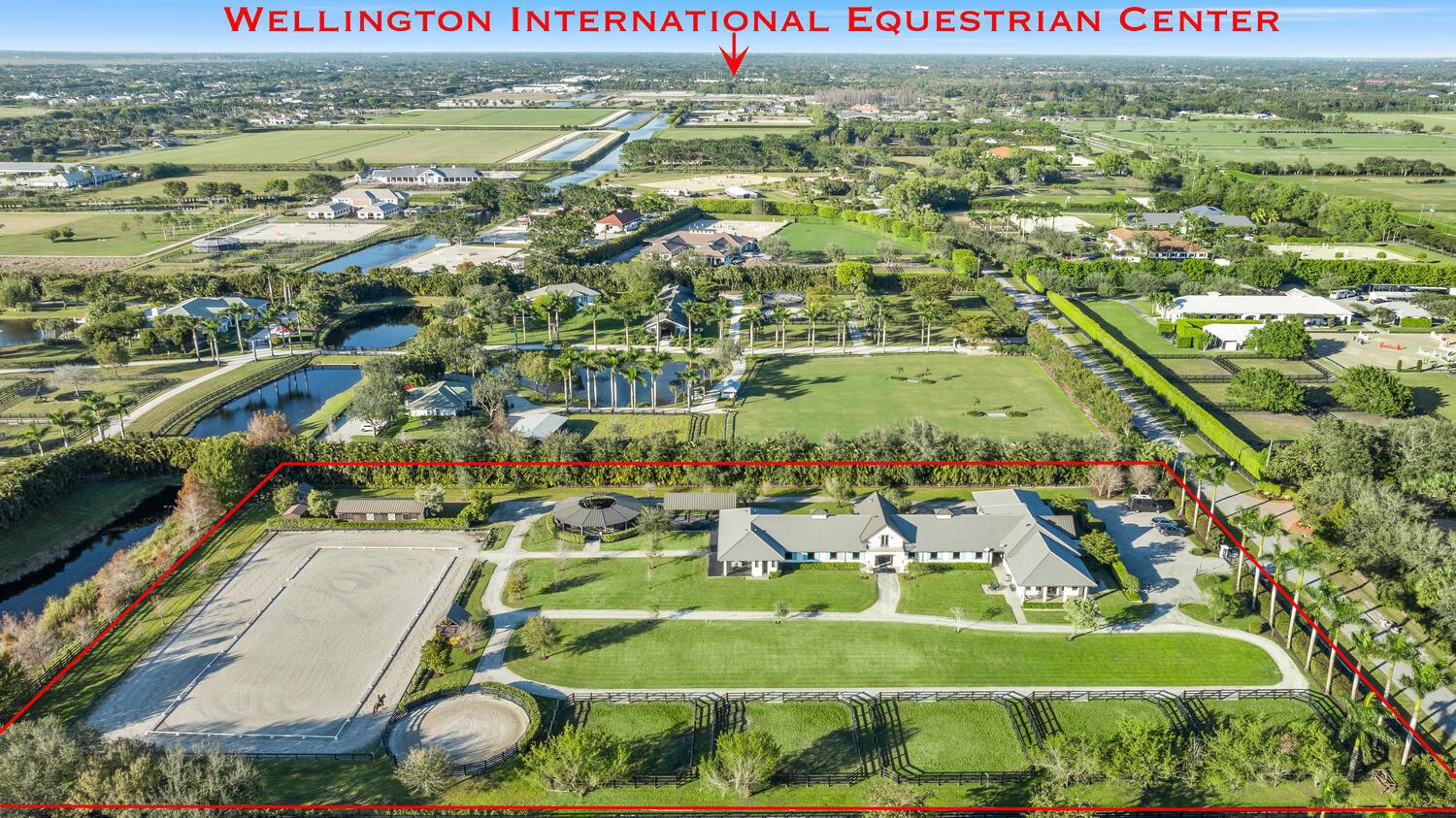 An aerial view of an equestrian estate featuring a large barn, riding arena, and paddocks — 4915 Stables Way, Wellington FL 33414, WELLINGTON, FL