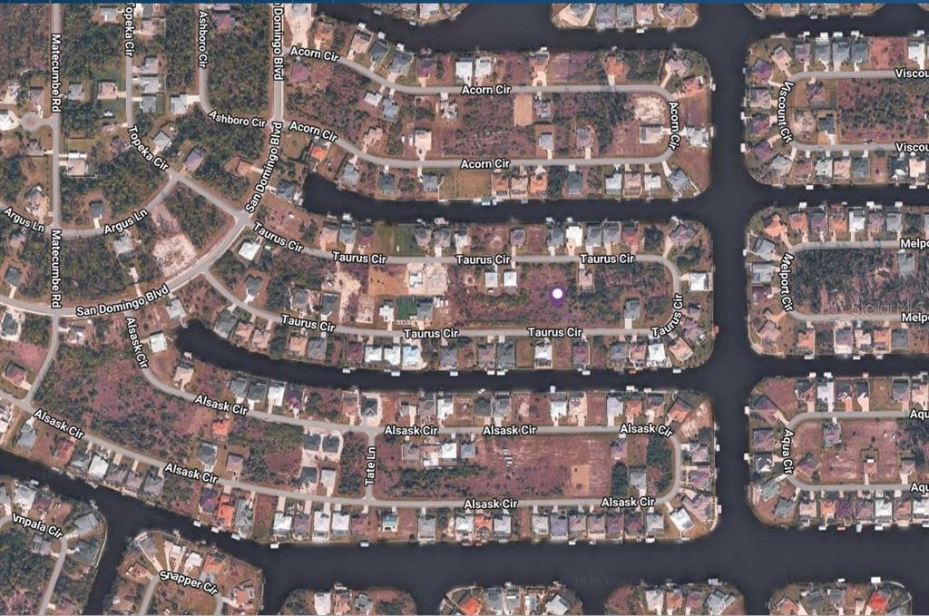 This aerial map shows a residential neighborhood with houses surrounding several canals and cul-de-sacs — 15269 TAURUS CIRCLE, PORT CHARLOTTE, FL
