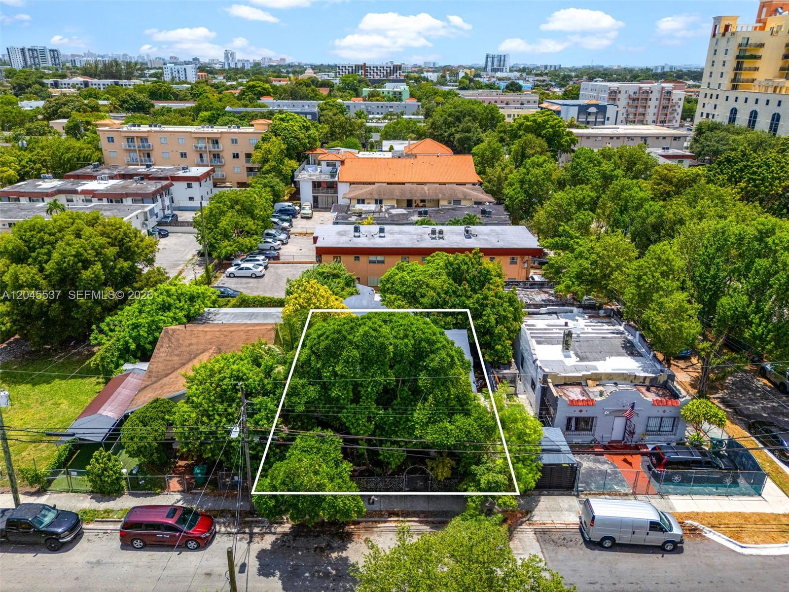 An aerial view shows a tree-covered residential lot outlined in white between two buildings — 210 SW 13th Ave, Miami FL 33135, MIAMI, FL