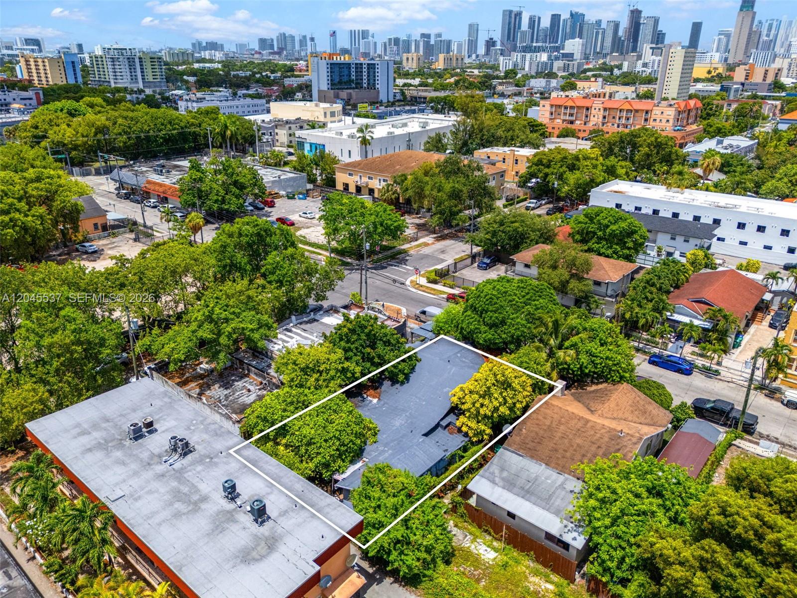 An aerial view shows a flat-roofed building outlined in white amidst trees and urban surroundings — 210 SW 13th Ave, Miami FL 33135, MIAMI, FL