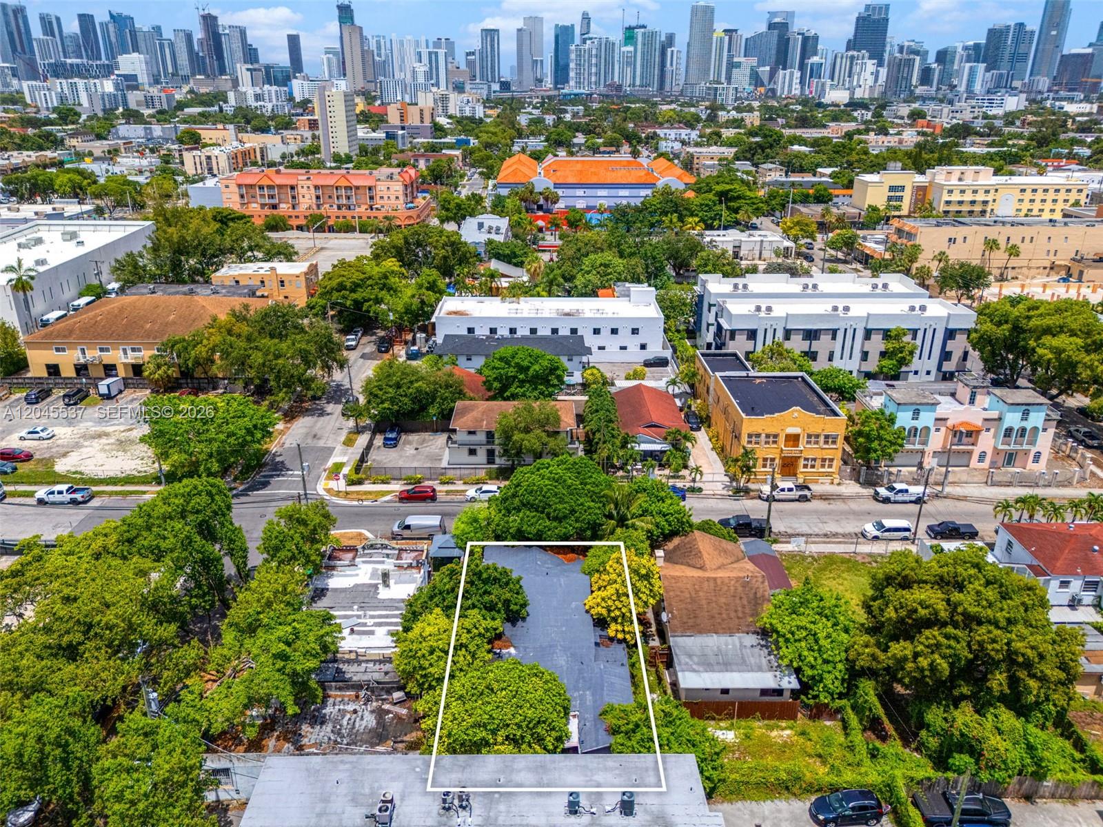 An aerial view shows a rectangular lot with a flat-roofed building surrounded by trees — 210 SW 13th Ave, Miami FL 33135, MIAMI, FL