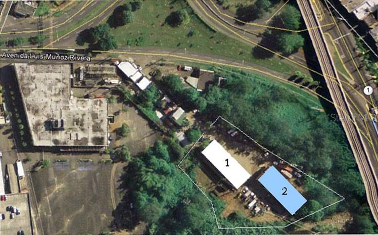An aerial view shows a property with two rectangular buildings outlined on a grassy lot — 1 MUÑOZ RIVERA, SAN JUAN, PR