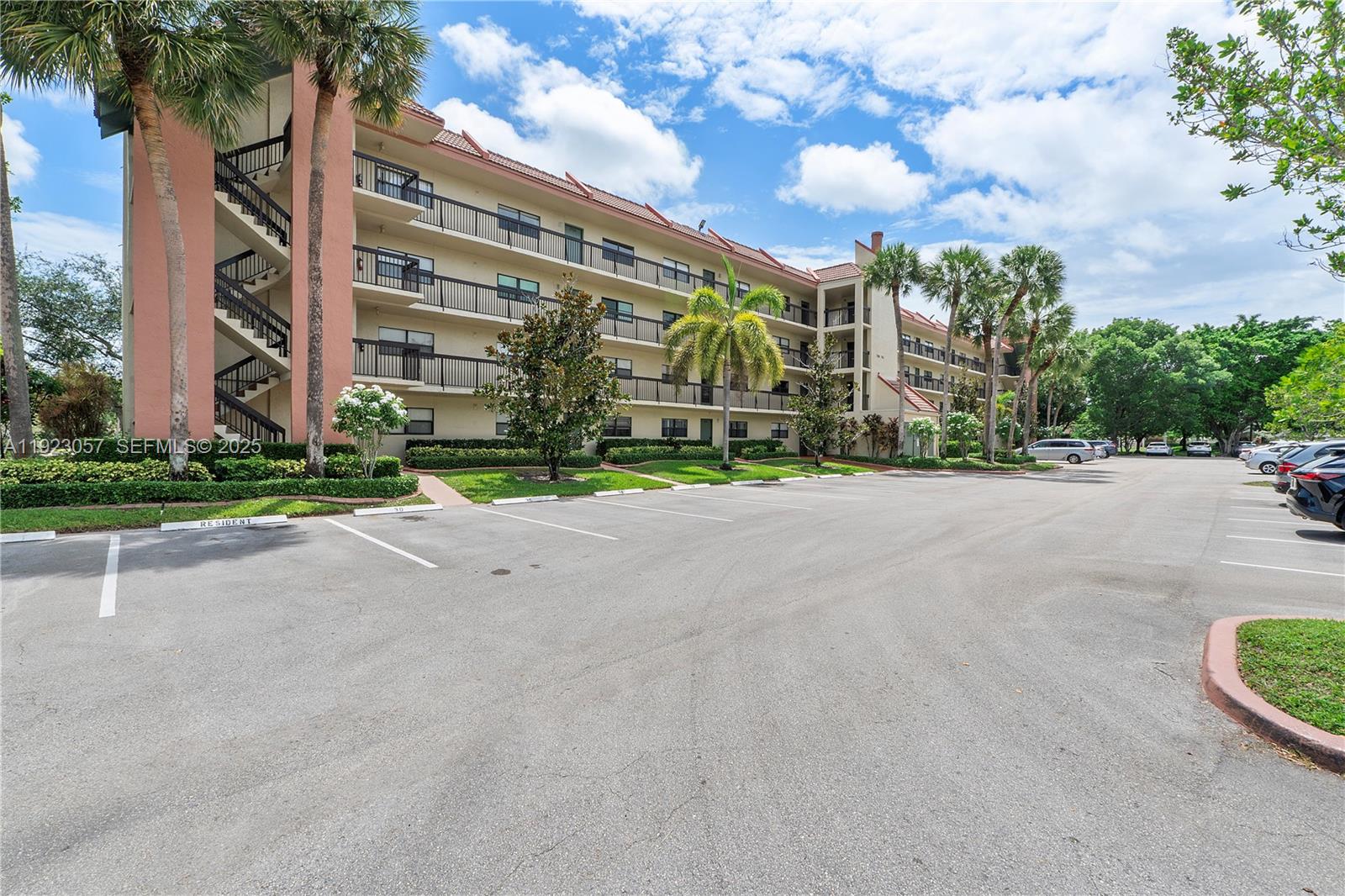 A multi-story apartment building with exterior staircases and a parking lot in front — 1706 Hammock Blvd # 1706, Coconut Creek FL 33063, COCONUT CREEK, FL