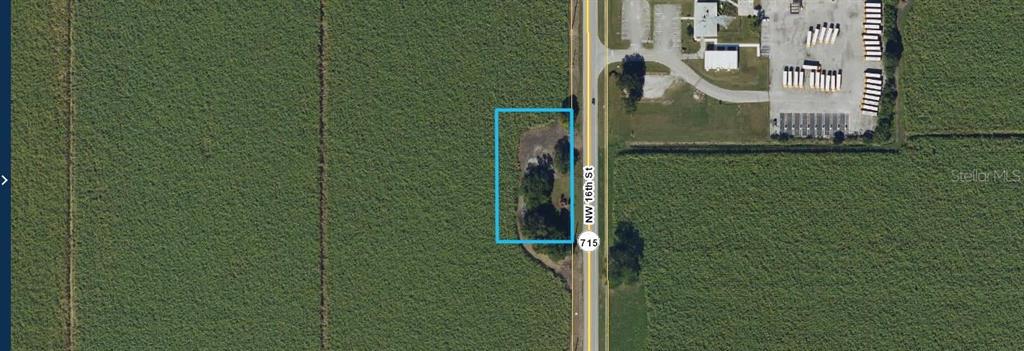 This aerial map shows a rectangular plot of land outlined in blue along a highway — 715 NW 16TH ST ROAD, BELLE GLADE, FL