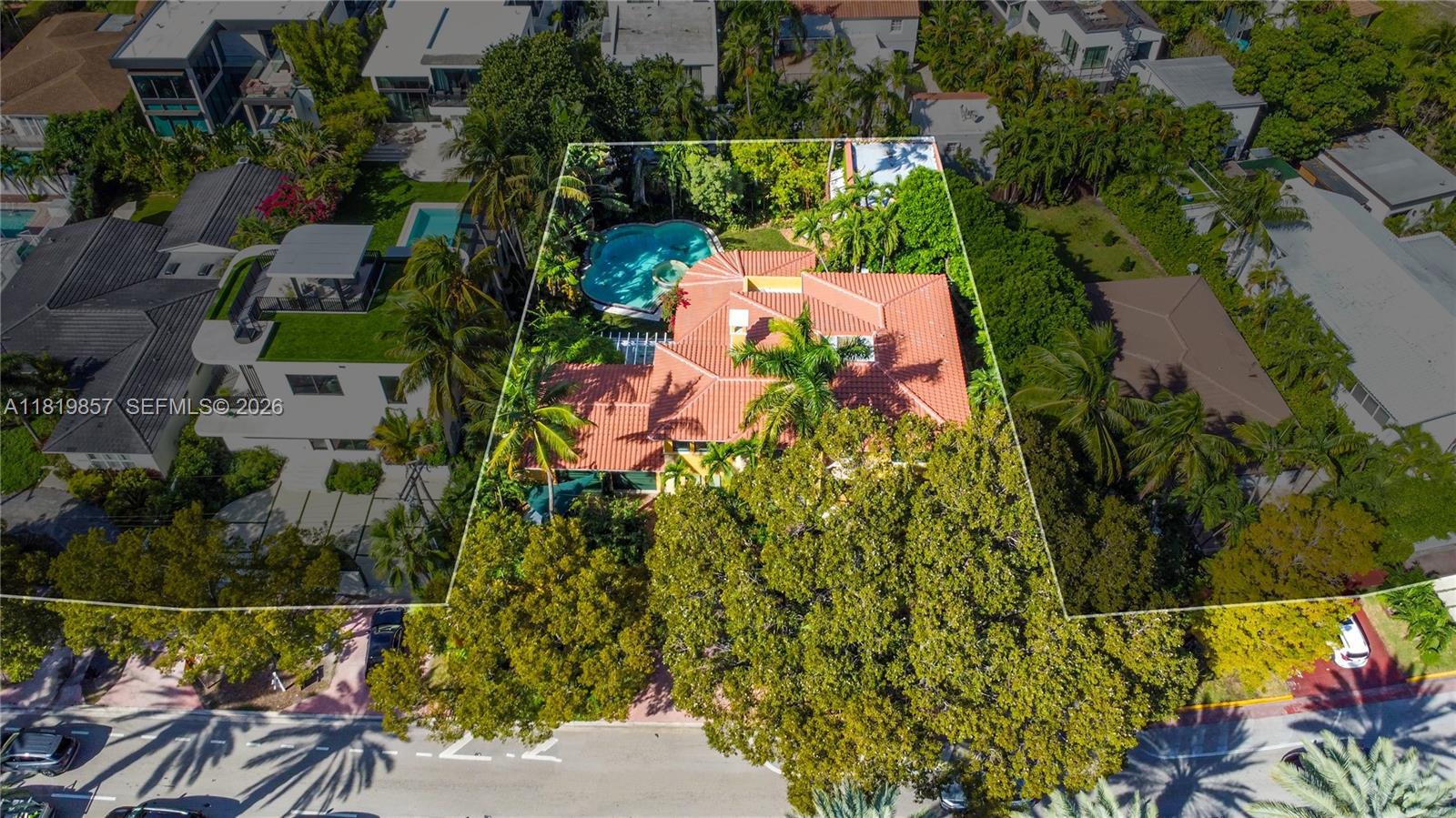An aerial view shows a house with a red tile roof and a backyard pool — 2050 Alton Rd, Miami Beach FL 33140, MIAMI BEACH, FL