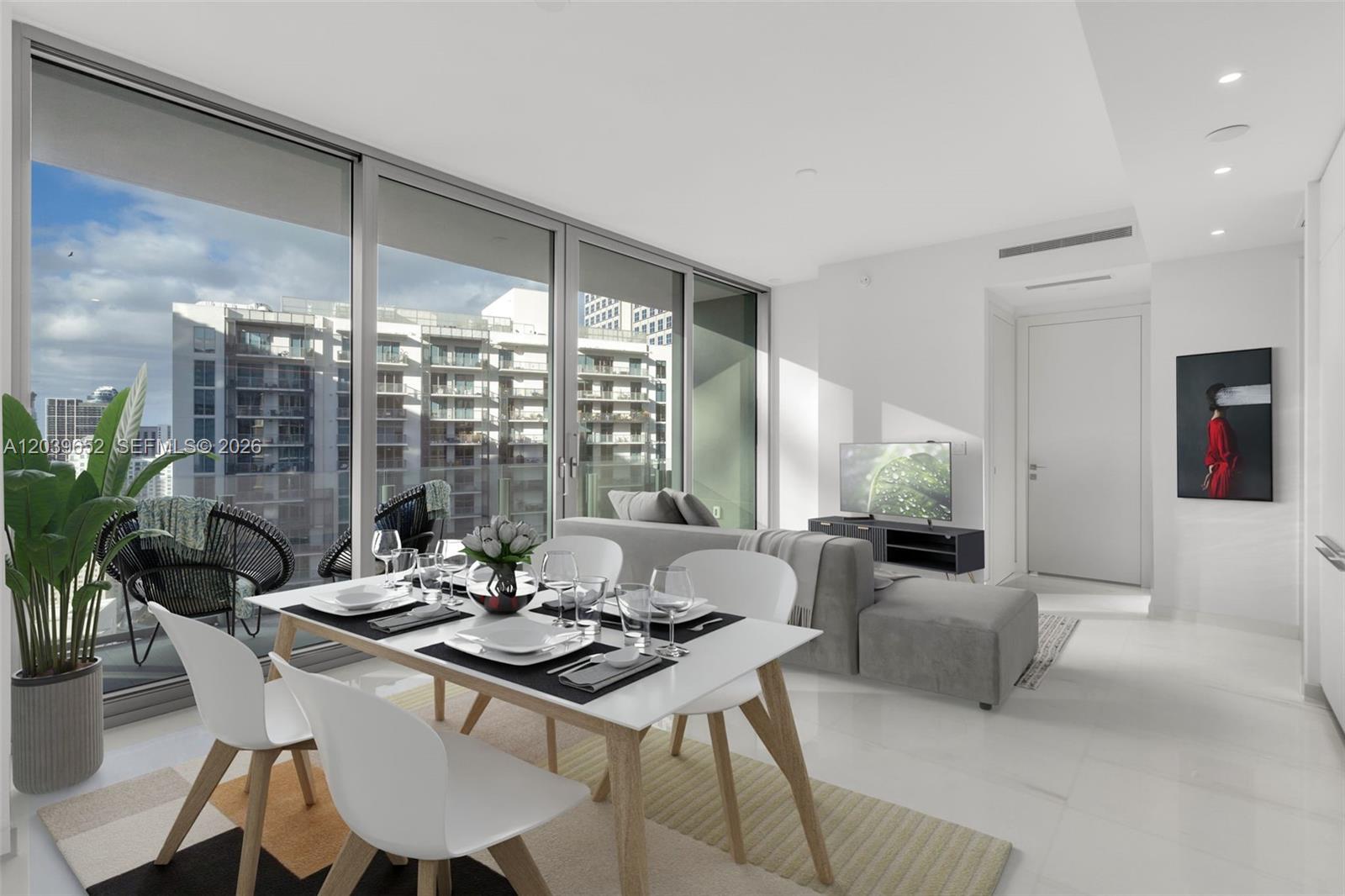A modern dining area and living room feature floor-to-ceiling windows overlooking a city skyline — 300 Biscayne Blvd Way # 4008, Miami FL 33131, MIAMI, FL