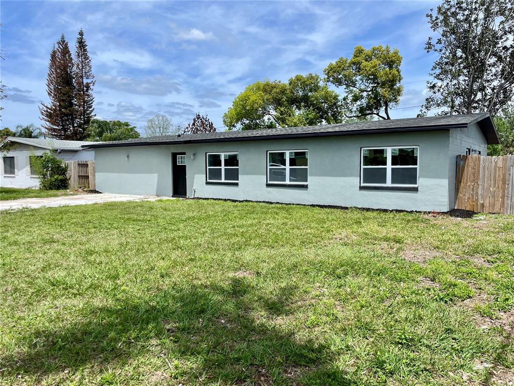 A single-story house with light green exterior walls, a dark roof, and a front lawn — 701 ALFRED DRIVE, ORLANDO, FL