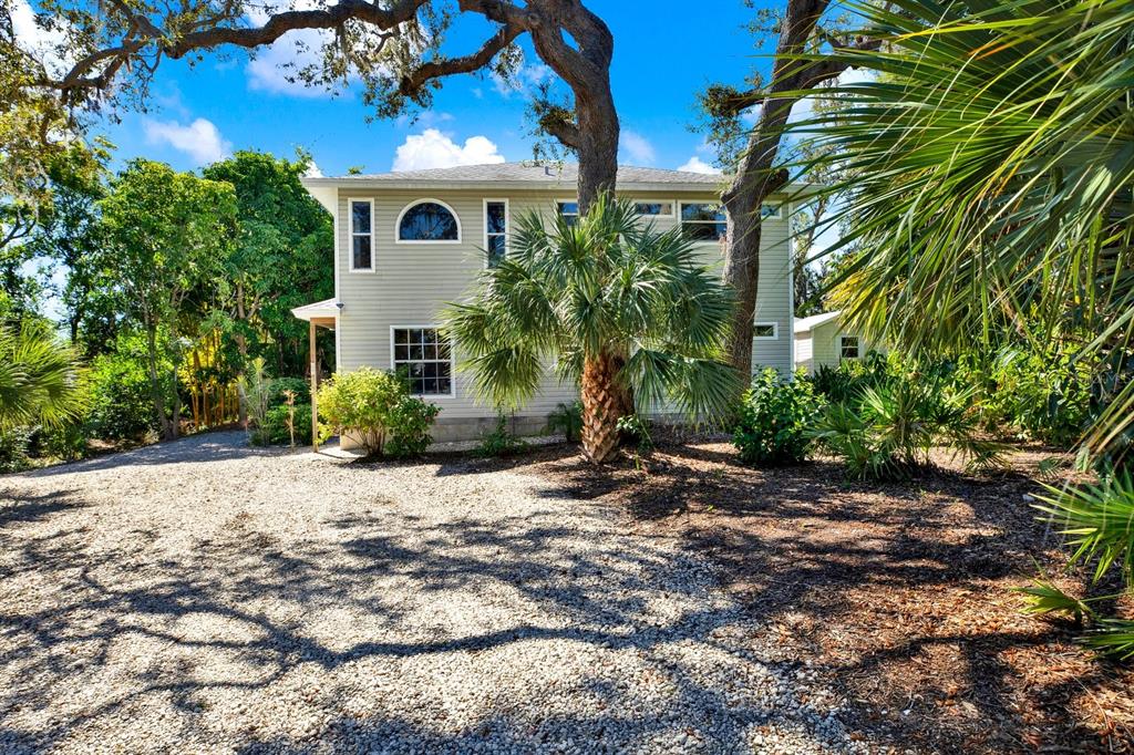 A two-story house with light gray siding, a turquoise front door, and a wooden deck — 201 GEORGIA AVENUE, CRYSTAL BEACH, FL