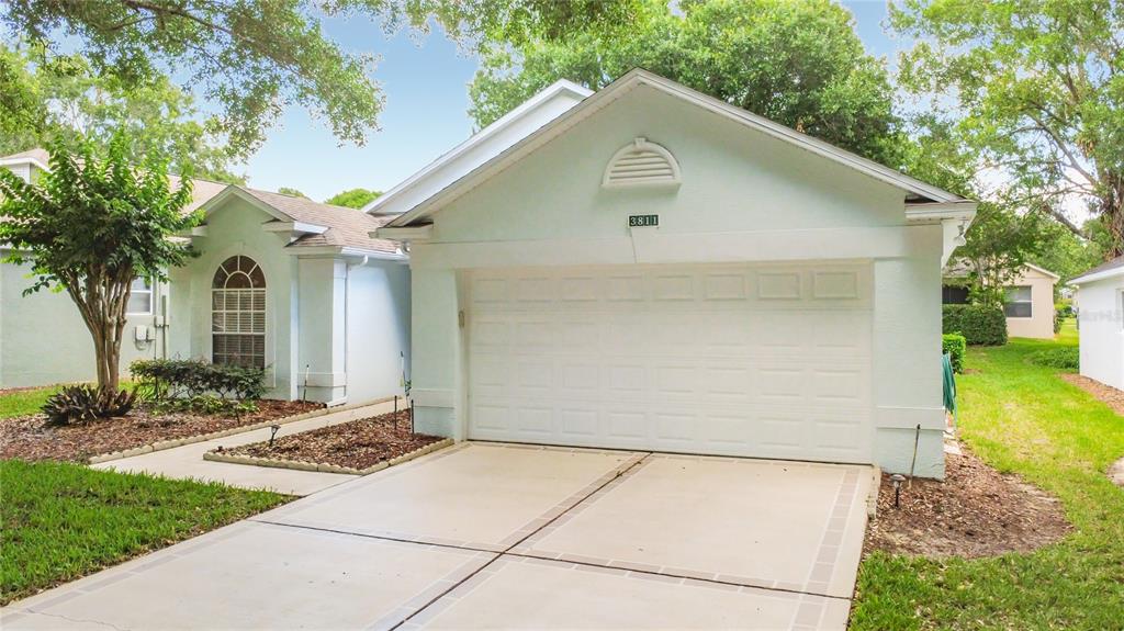 A light blue single-story house with a two-car garage and a concrete driveway — 3811 WESTERHAM DRIVE, CLERMONT, FL