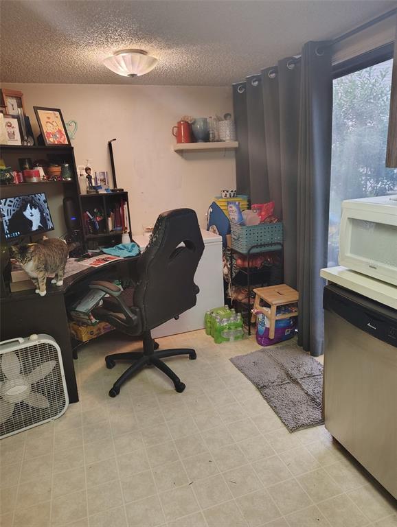 A room featuring a desk, a gaming chair, a small freezer, and a sliding glass door — 2962 MORGAN COMBEE ROAD, LAKELAND, FL