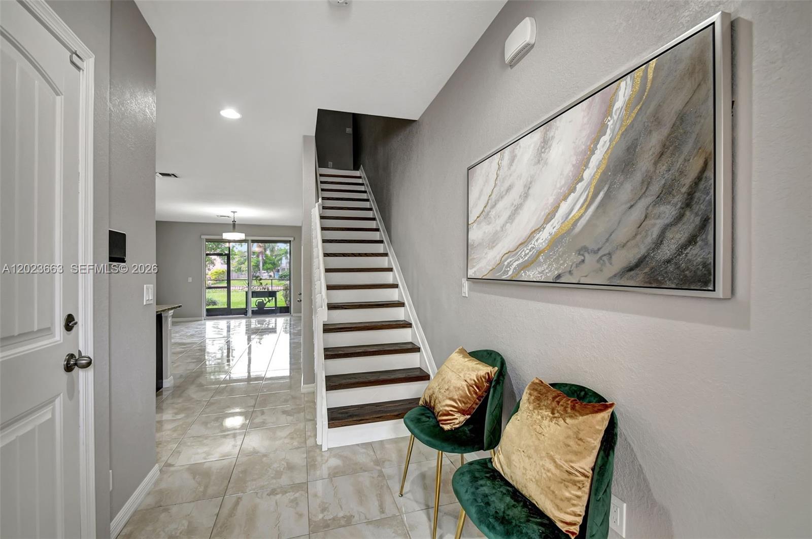 The exterior view shows a blue front door under an arched entryway with brick pavers — 1119 Vermilion Dr, Lake Worth FL 33461, LAKE WORTH, FL