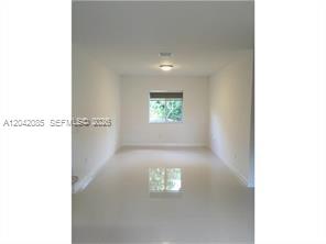 A two-story duplex building features a concrete driveway with two parked cars — 1029 SW 11th Ave # 0, Miami FL 33130, MIAMI, FL