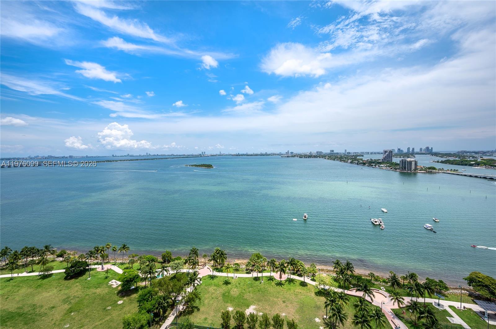An elevated view of a coastal park with palm trees overlooking a large bay — 1800 N Bayshore Dr # 2503, Miami FL 33132, MIAMI, FL