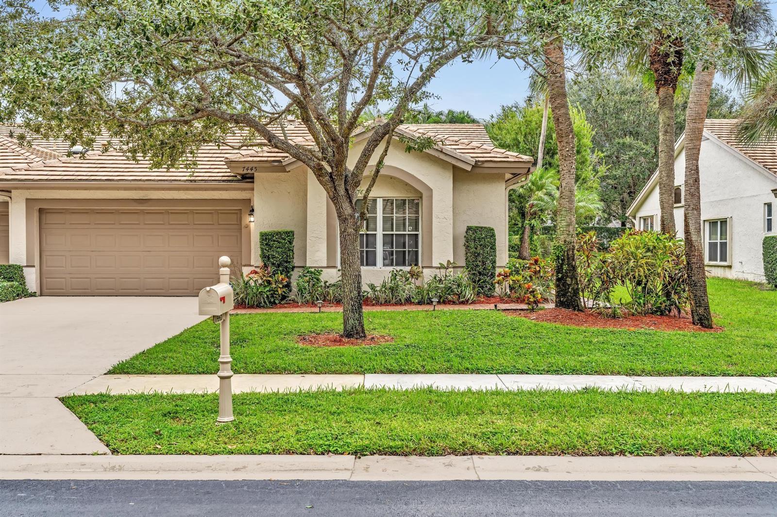 A single-story house with a beige stucco exterior, a tile roof, and a front lawn — 7445 Rockbridge Circle, Lake Worth FL 33467, LAKE WORTH, FL