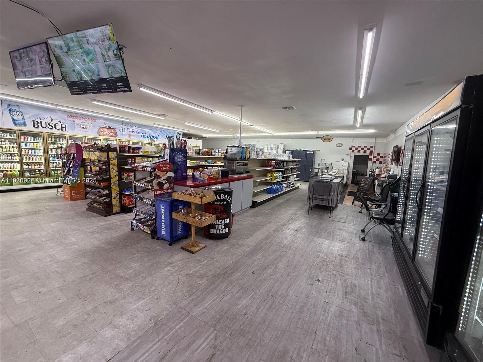 The interior of a convenience store features shelving units, beverage coolers, and a service counter — 2243 Simms St, Hollywood FL 33020, HOLLYWOOD, FL