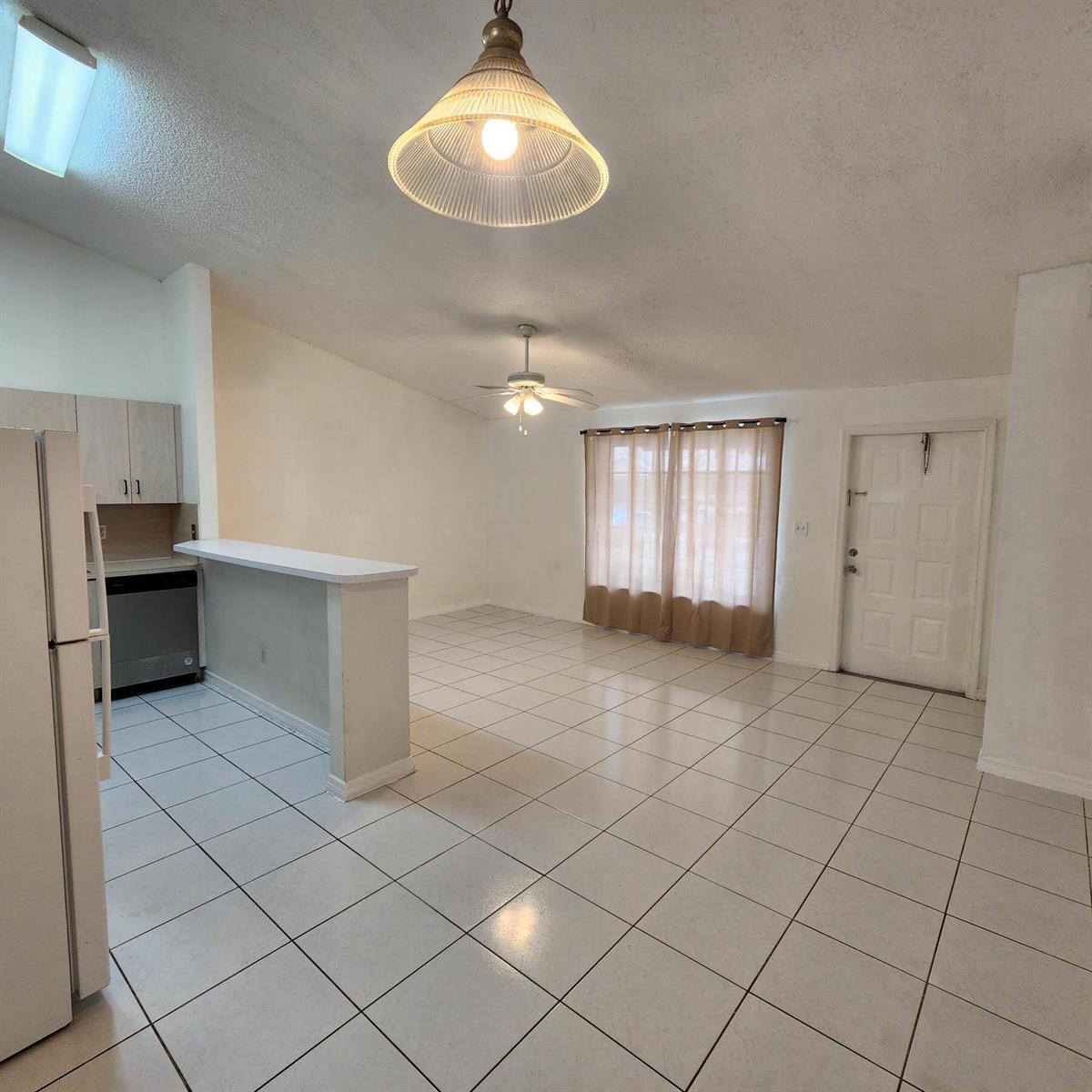 A beige exterior wall features a front door and a window above a parking space — 500 NE 3rd Street # 109, FL 33009, FL