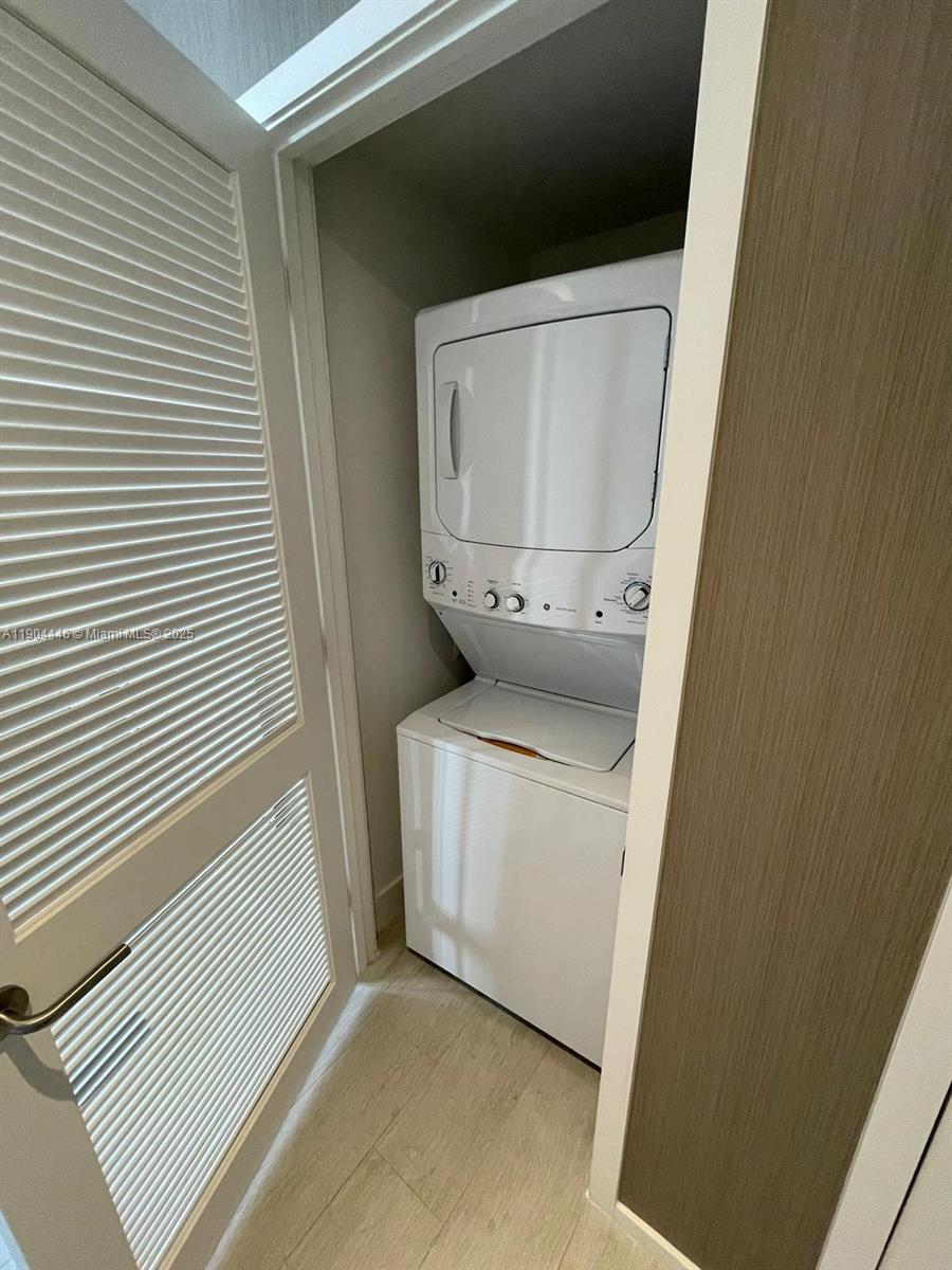 A stacked white washer and dryer unit is located inside a small utility closet — 4010 S Ocean Dr # R3306, Hollywood FL 33019, HOLLYWOOD, FL