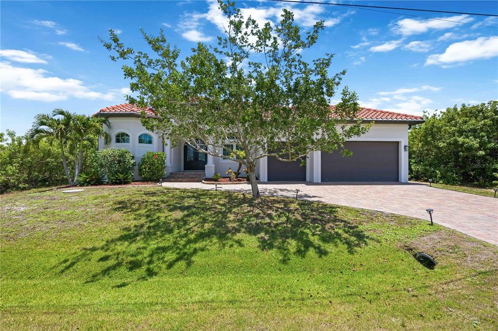A single-story house with a tile roof, a two-car garage, and a paved driveway — 10386 WINNIPEG STREET, PORT CHARLOTTE, FL