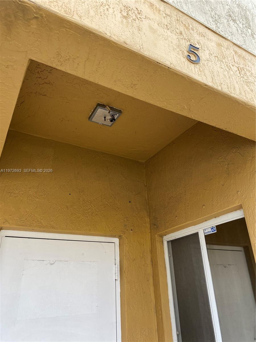 An exterior view of a building entrance with a door, a window, and the number five — 2431 W 80th St # C, Hialeah FL 33016, HIALEAH, FL