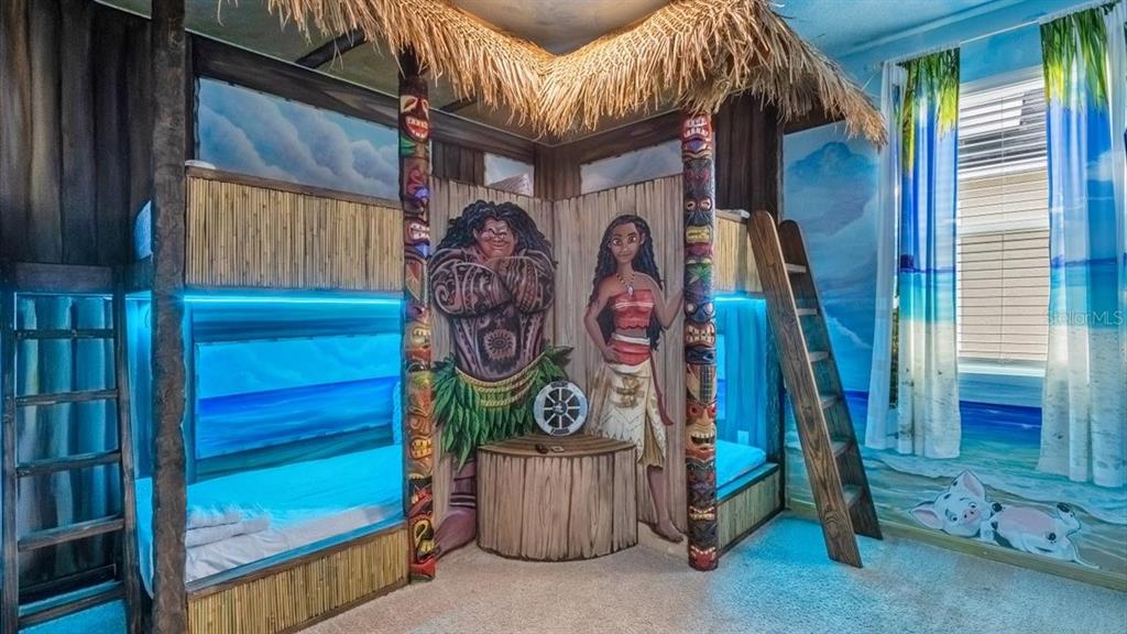 A themed bedroom features Moana-inspired bunk beds with a thatched roof and tiki-style posts — 2089 TROPICAL PALMS CIRCLE, KISSIMMEE, FL