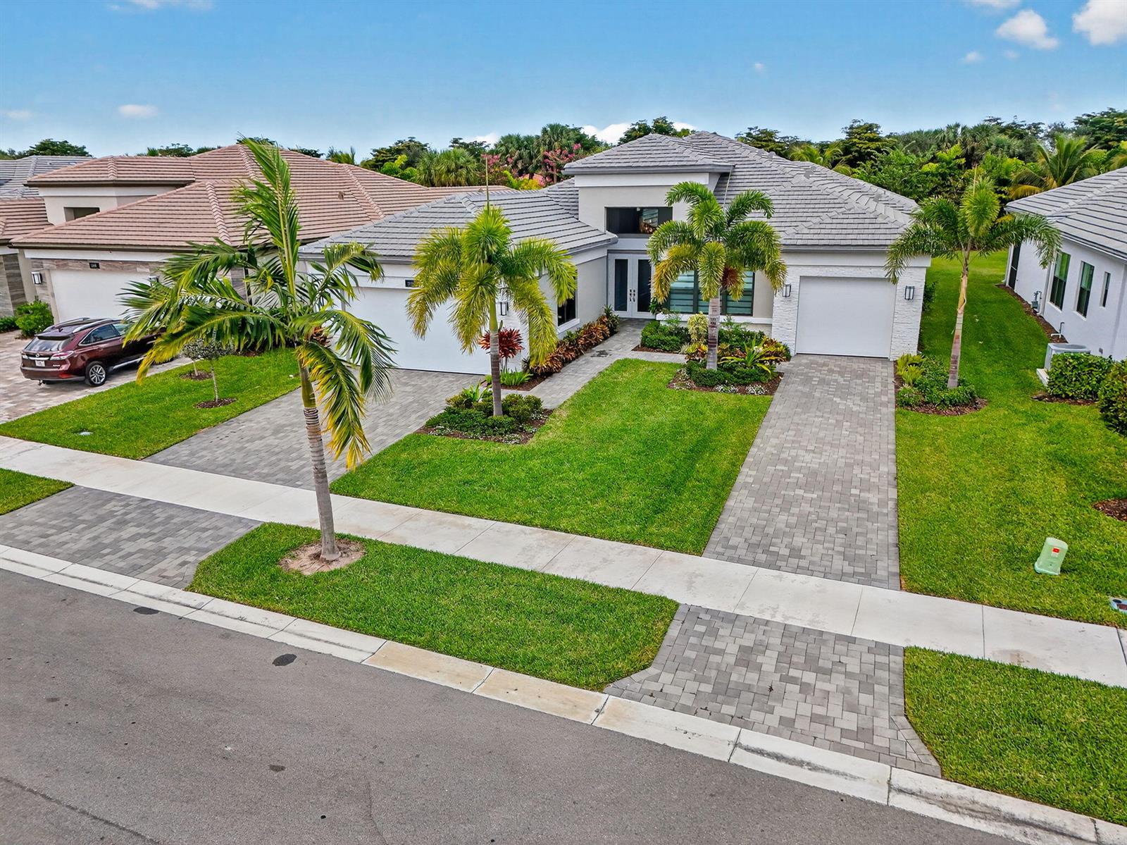 An aerial view of a single-story house with a paver driveway and palm trees — 11104 Glen Orchard Lane, Boynton Beach FL 33473, BOYNTON BEACH, FL