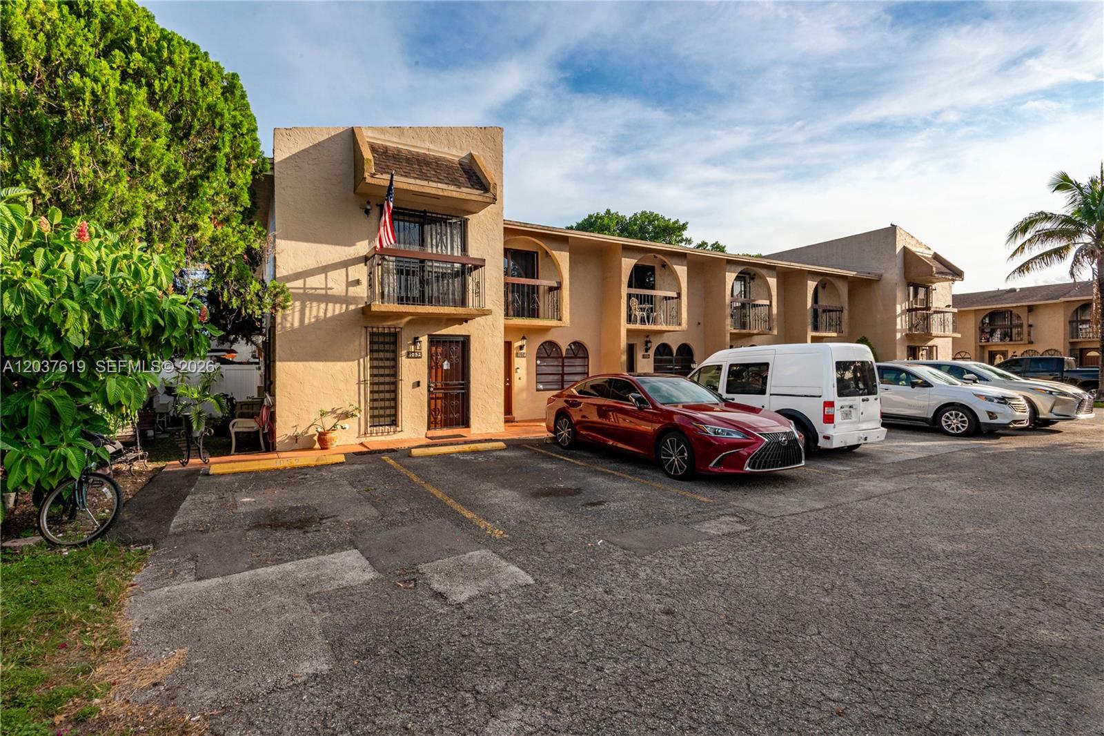 A multi-story apartment building with beige stucco walls and a parking lot in front — 1052 W 79th St # 11, Hialeah FL 33014, HIALEAH, FL