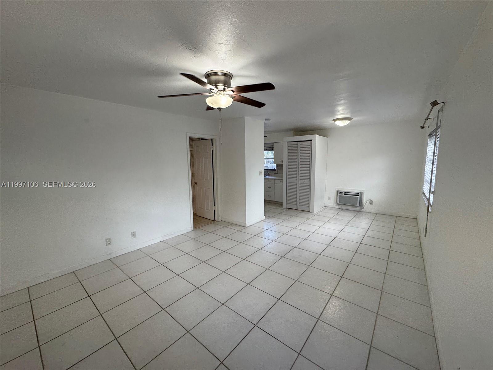 An interior view of a room with white walls, tiled floors, and a ceiling fan — 2000 Buchanan St # 11, Hollywood FL 33020, HOLLYWOOD, FL