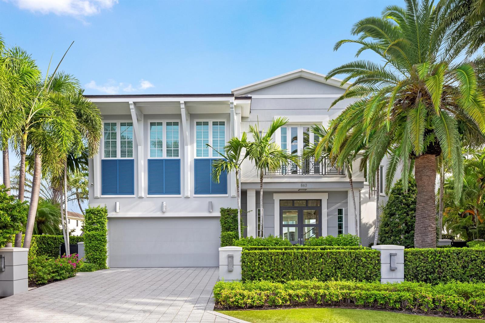 A two-story gray house with blue shutters, a paved driveway, and palm trees in front — 863 Enfield Street, Boca Raton FL 33487, BOCA RATON, FL