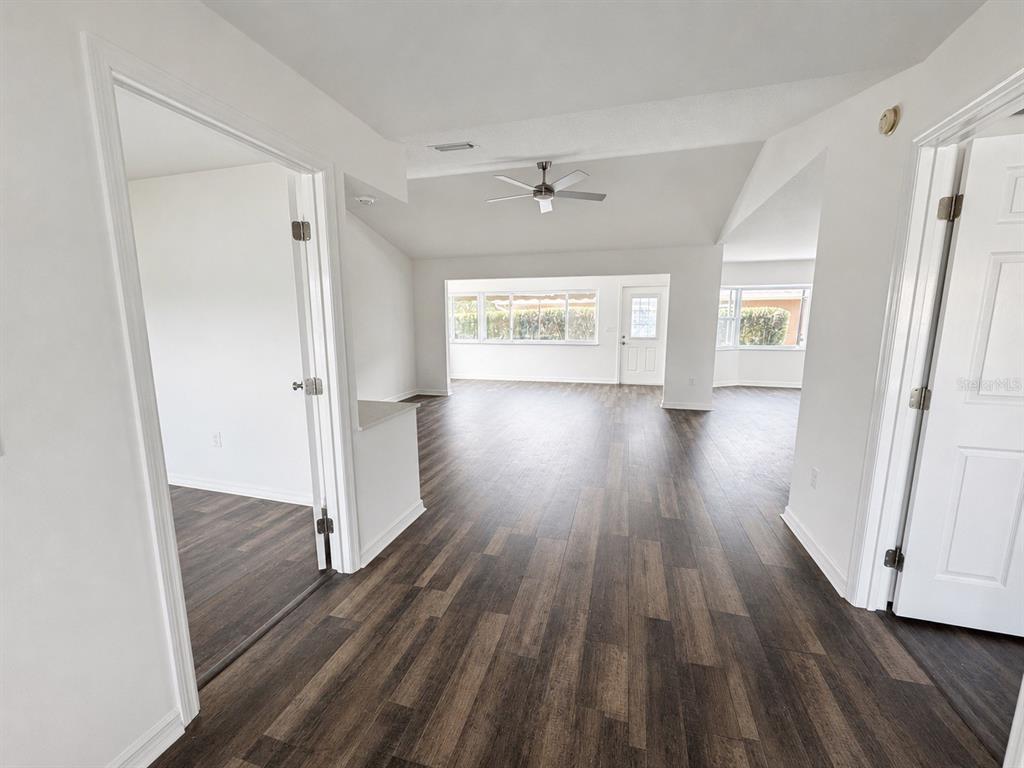 A single-story house with a large oak tree, gray siding, and a concrete driveway — 11584 SE 175TH STREET, SUMMERFIELD, FL