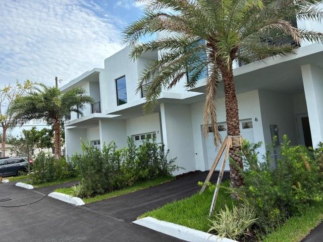 A modern white two-story townhouse exterior features a palm tree and a paved driveway — 2511 Pierce St # 6, Hollywood FL 33020, HOLLYWOOD, FL