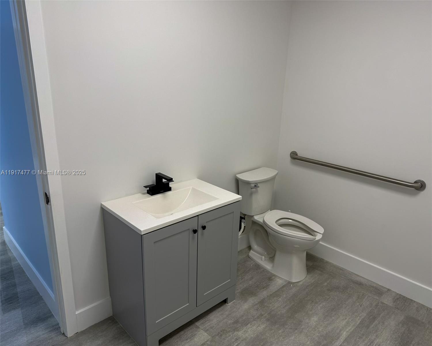 A bathroom features a gray vanity with a white countertop, a toilet, and a grab bar — 9447 SW 56th St # 49, Miami FL 33165, MIAMI, FL