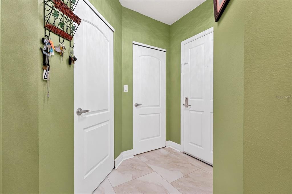 An entryway features green walls, white doors, and light-colored tile flooring — 4516 SEAGULL DRIVE UNIT 719, NEW PORT RICHEY, FL