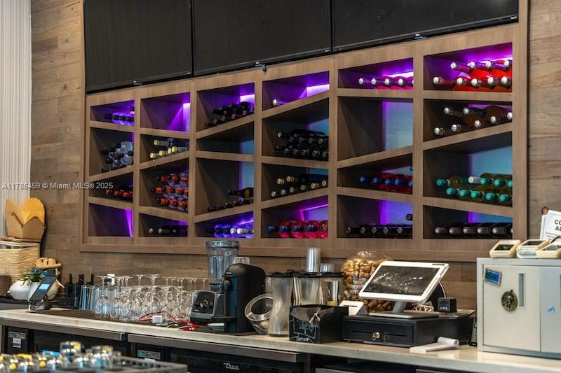 A bar area features a wooden wine rack with purple accent lighting above a service counter — 275 NE 18th St # CU-2, Miami FL 33132, MIAMI, FL