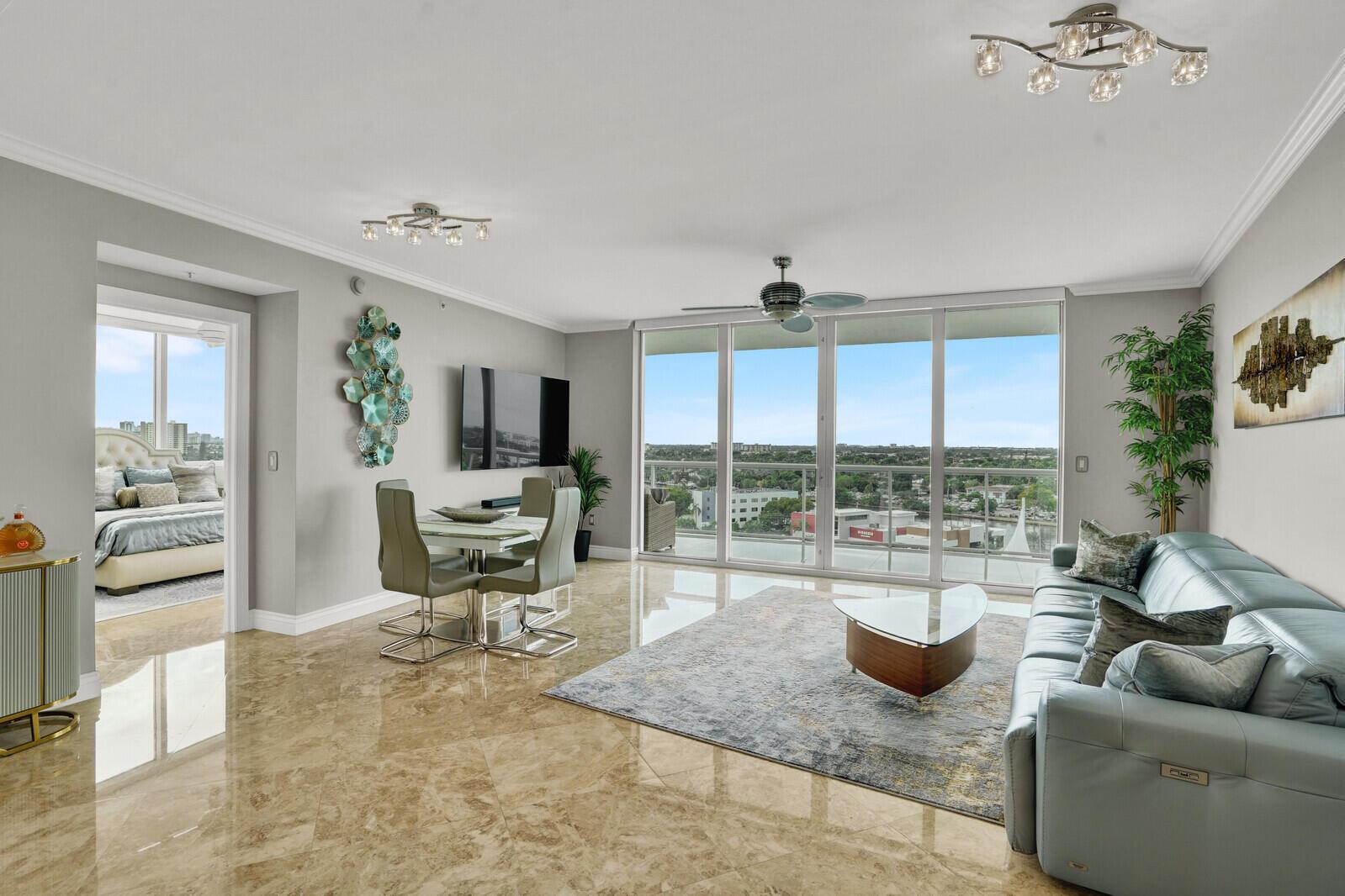 A living and dining area features marble floors, a blue leather sofa, and floor-to-ceiling windows — 1 N Ocean Boulevard # 814, Pompano Beach FL 33062, POMPANO BEACH, FL